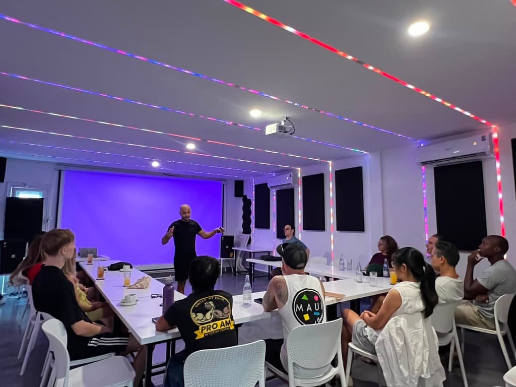 Group listening to Gilad under the coloured ceiling lights
